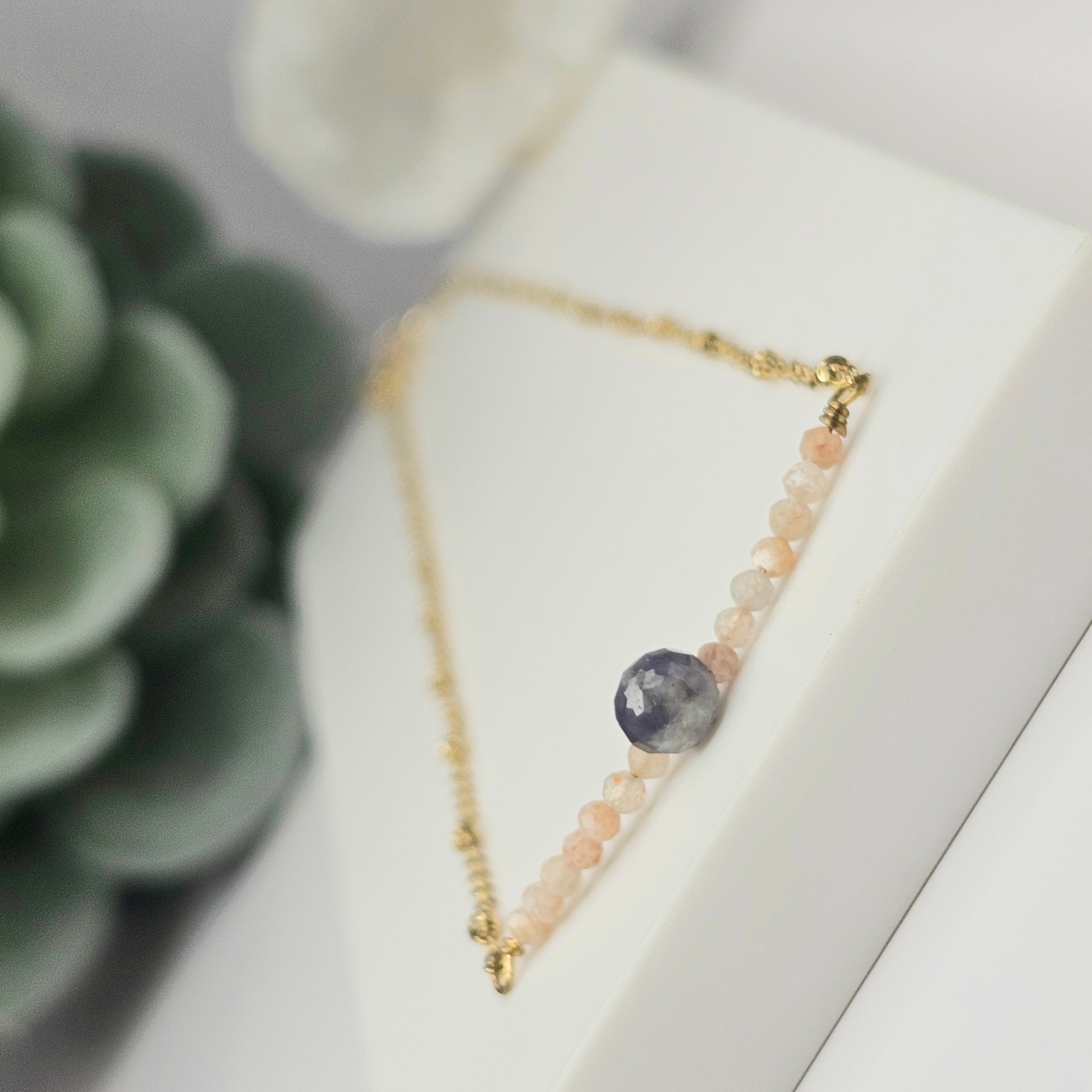 Gold toned stainless steel chain adorned with dainty Lapis Lazuli and Sunstone beads.