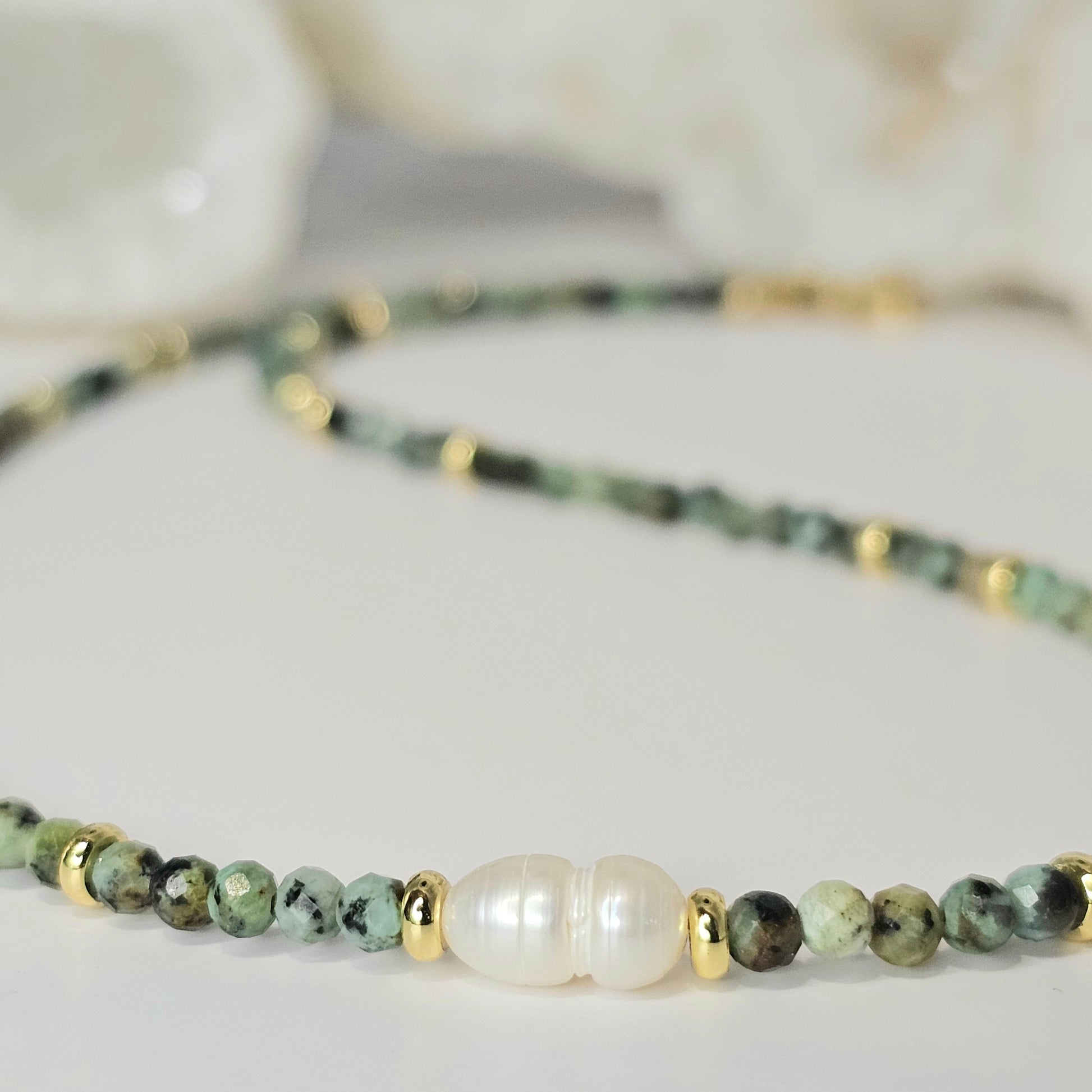 Delicate, faceted African Turquoise bead necklace with focal 8mm Freshwater Pearl and gold toned stainless steel clasp.