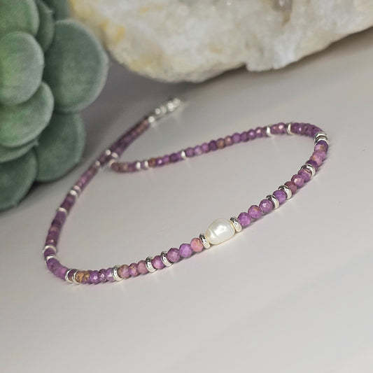 Delicate, faceted Lepidolite bead necklace with focal 8mm Freshwater Pearl and silver toned stainless steel clasp.