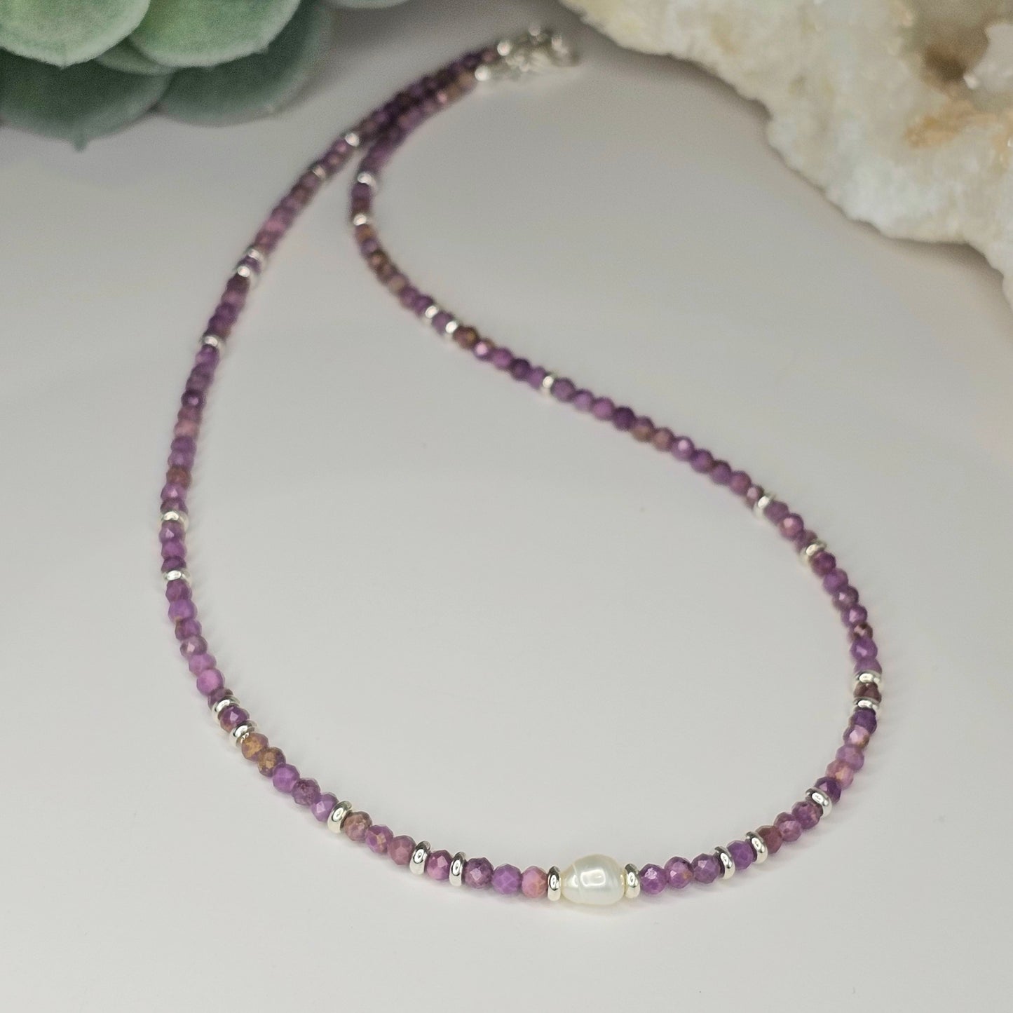 Delicate, faceted Lepidolite bead necklace with focal 8mm Freshwater Pearl and silver toned stainless steel clasp.