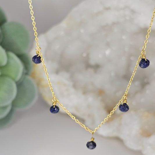 Fine gold toned stainless steel chain adorned with five dainty Lapis Lazuli beads.