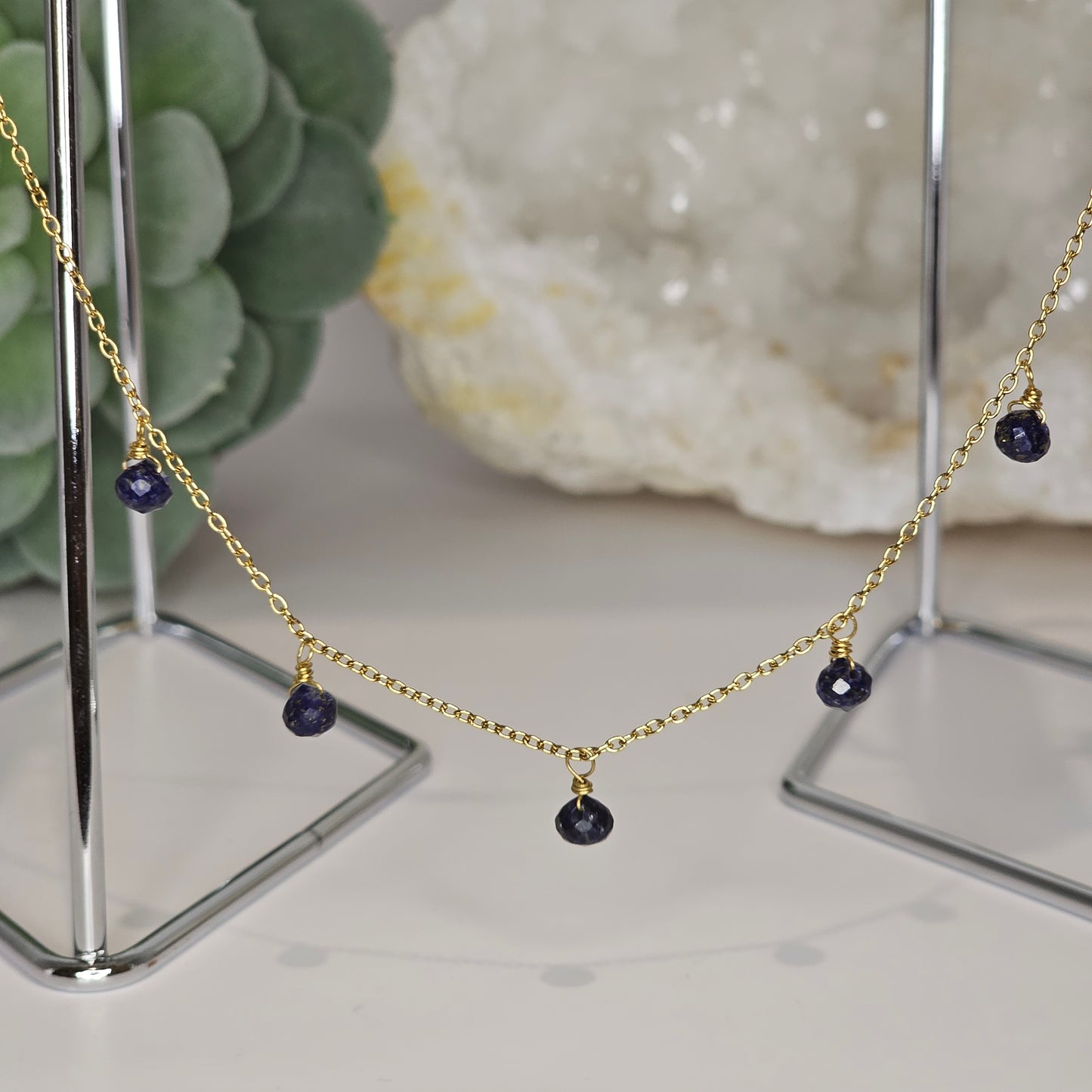 Fine gold toned stainless steel chain adorned with five dainty Lapis Lazuli beads.