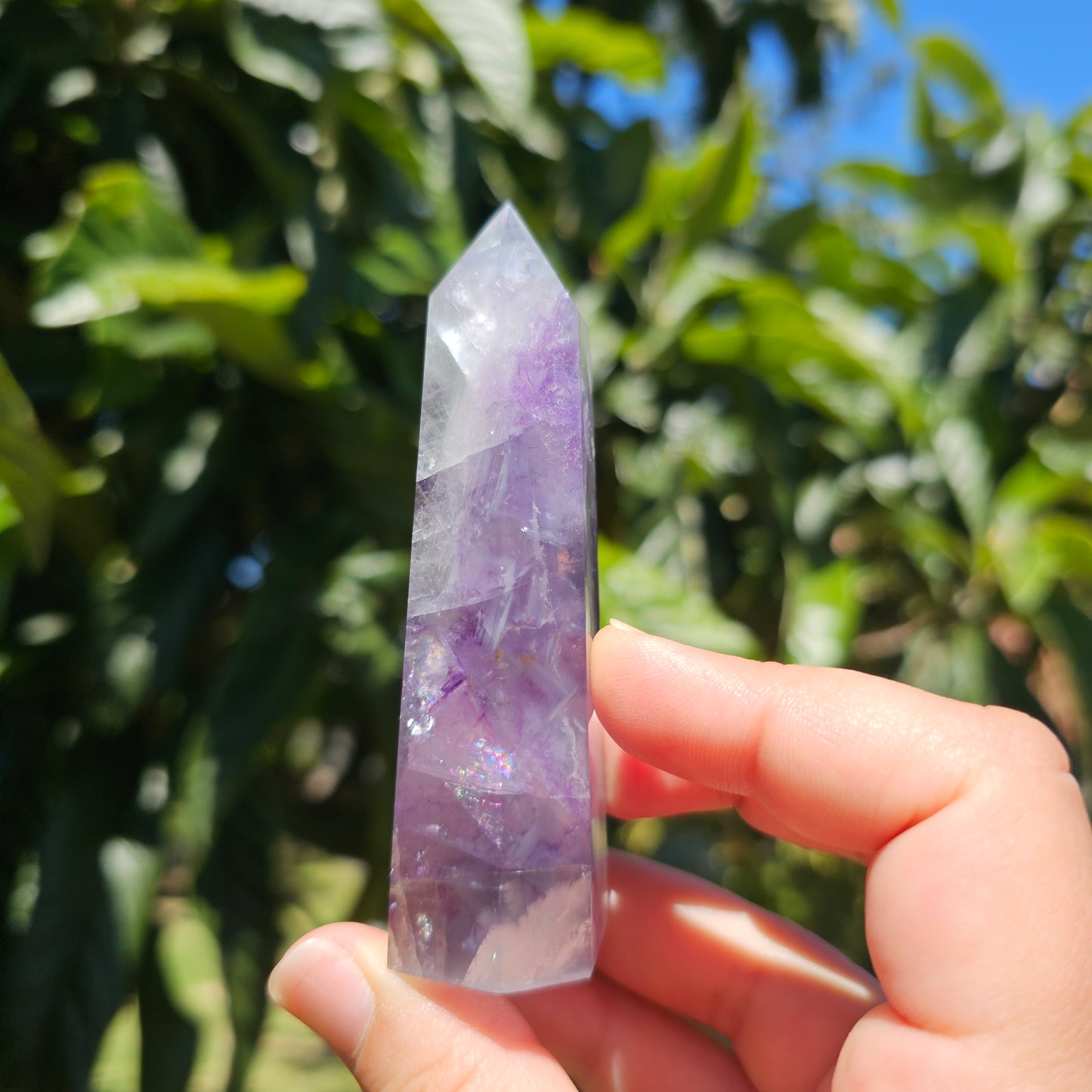 Spectacular clear Fluorite tower with vibrant purple, pastel blue &amp; pastel green banding. Also has beautiful rainbows throughout.