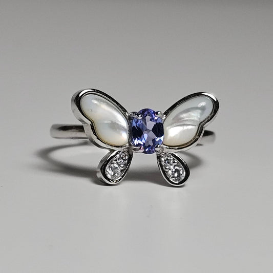 Adjustable sterling silver ring features a butterfly design with a stunning Tanzanite, shell and zircons.