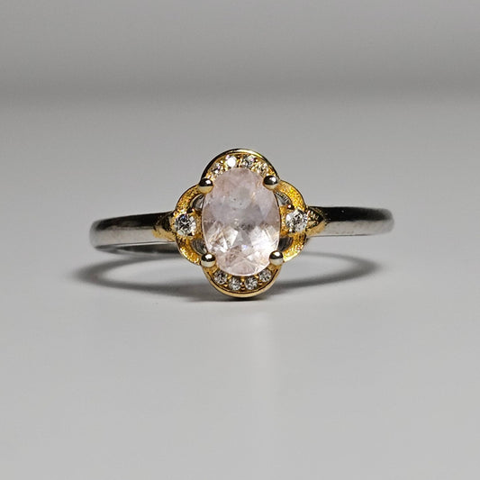 Adjustable sterling silver ring features a stunning oval cut Morganite centre stone and zircons on a gold plated crown.