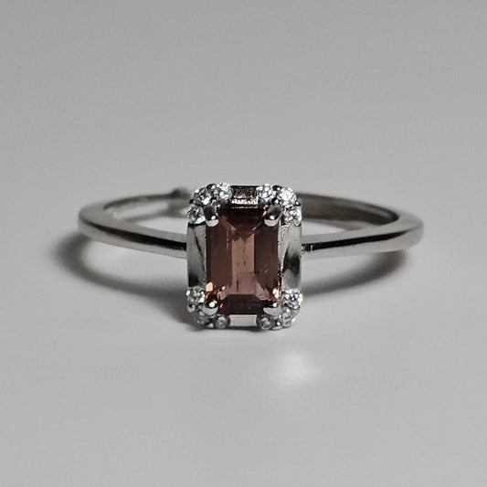 Adjustable petite ring crafted from sterling silver and features a beautiful dainty Tourmaline baguette with a zircon accented crown.