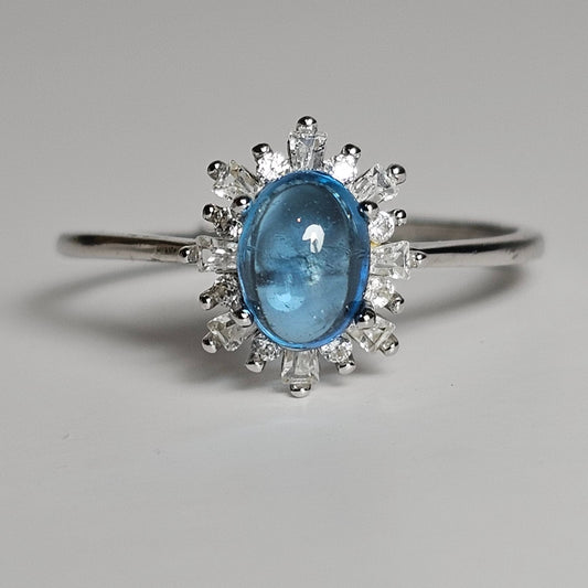 This adjustable floral burst ring is crafted from sterling silver and features a stunning oval shaped Swiss Blue Topaz centre stone surrounded with zircon.