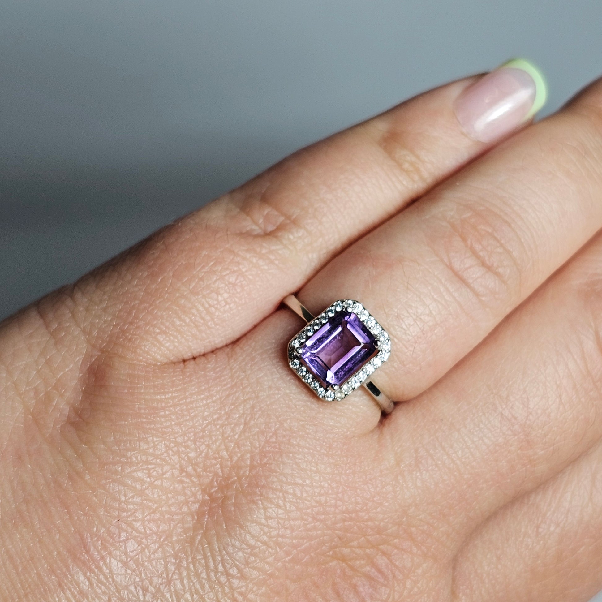 This ring is crafted from sterling silver and features a gorgeous rectangular shaped Amethyst with a Zircon accented crown.