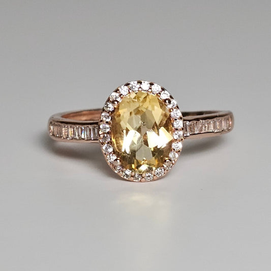 This adjustable ring is crafted from rose gold plated sterling silver and features a gorgeous oval Citrine centre stone with a Zircon accented crown and shoulder ring band.