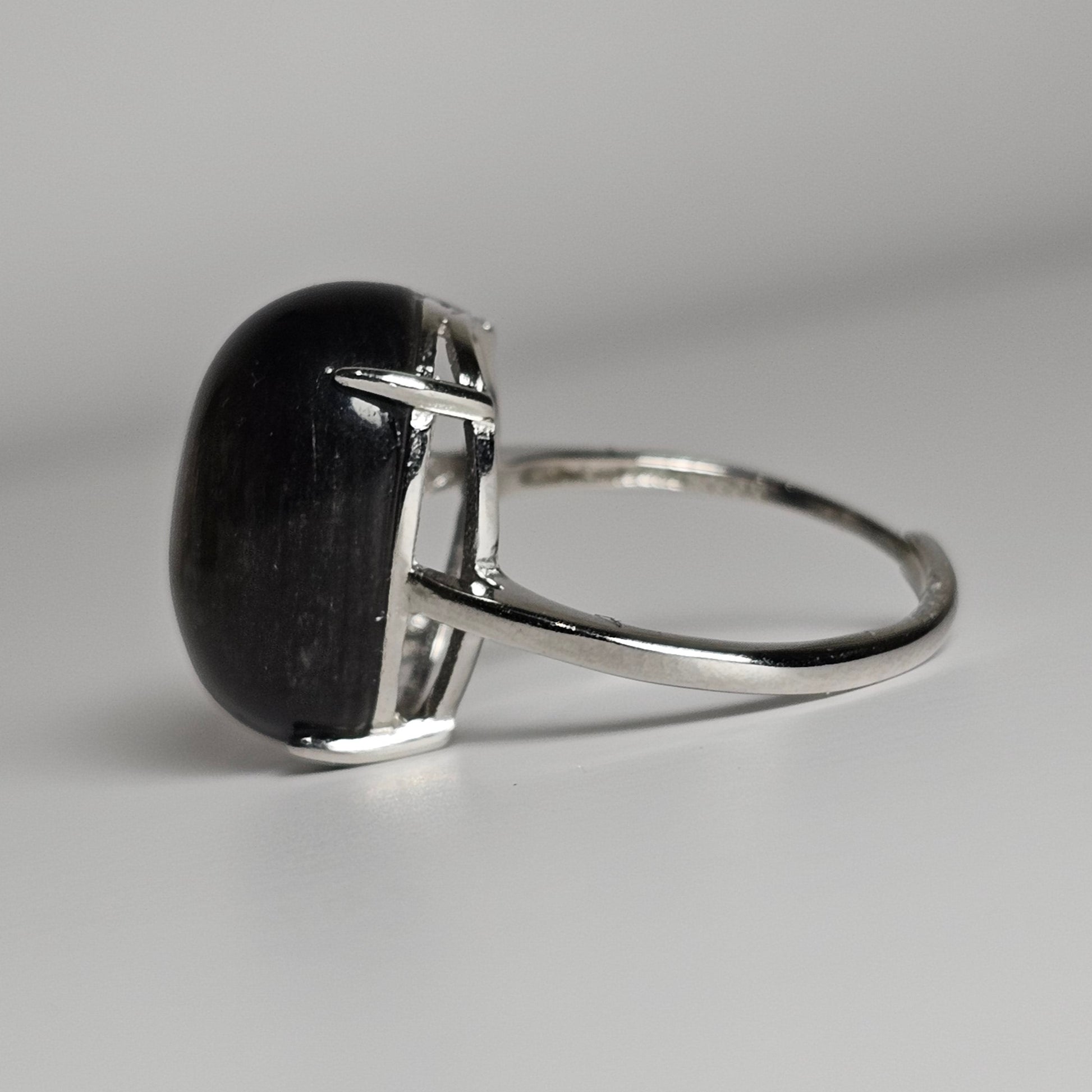 This adjustable bold ring is crafted from sterling silver and features a stunning oval shaped Silver Sheen Obsidian.