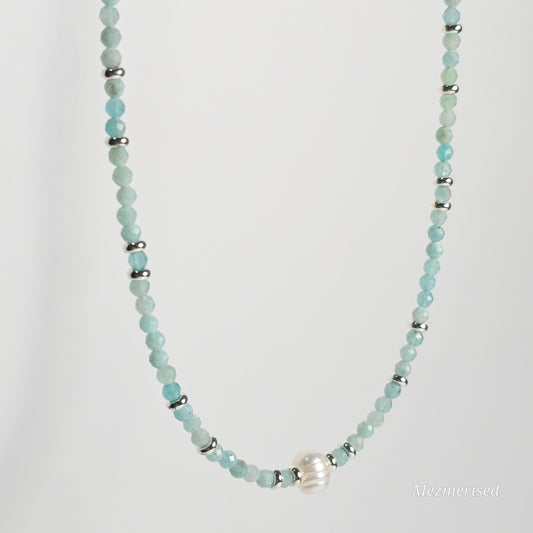 Side angle view of Amazonite pearl necklace hanging.