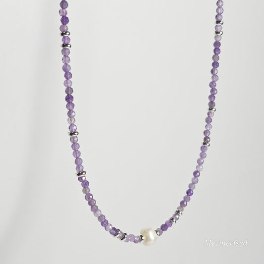 Side angle view of Amethyst pearl necklace hanging.