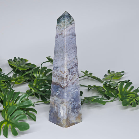 Moss agate blue chalcedony crystal tower showing natural patterns and polished obelisk shape