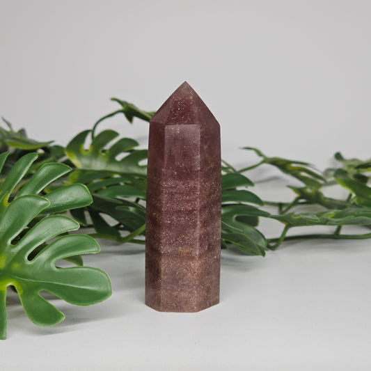 Dark strawberry quartz tower crystal showing rich pink colour and polished point