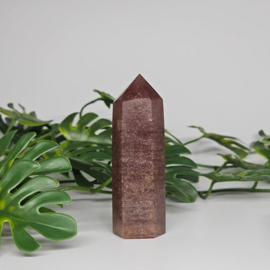 Dark strawberry quartz tower crystal showing rich pink colour and polished point