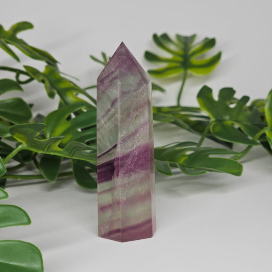 Fluorite tower with soft purple and green tones showing natural banding and polished finish