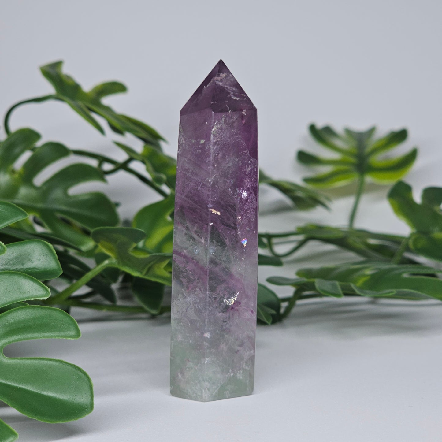 Fluorite crystal tower side view displaying layered colour zones and translucent natural formation