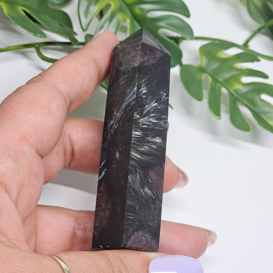 Garnet and Arfvedsonite crystal tower held in hand showing Arfvedsonite fireworks blades