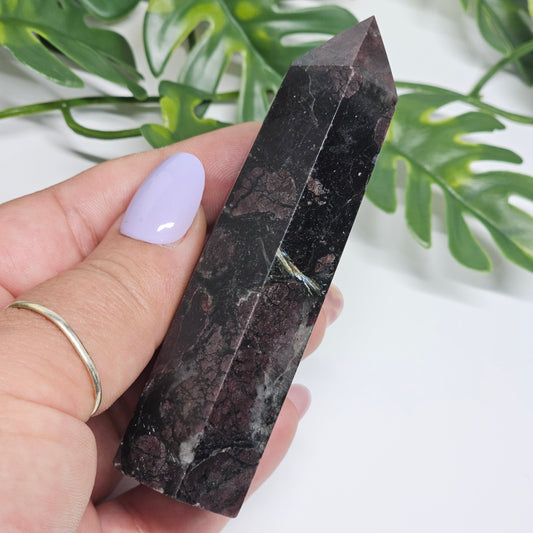 Garnet and Arfvedsonite crystal tower held in hand showing size and natural formation