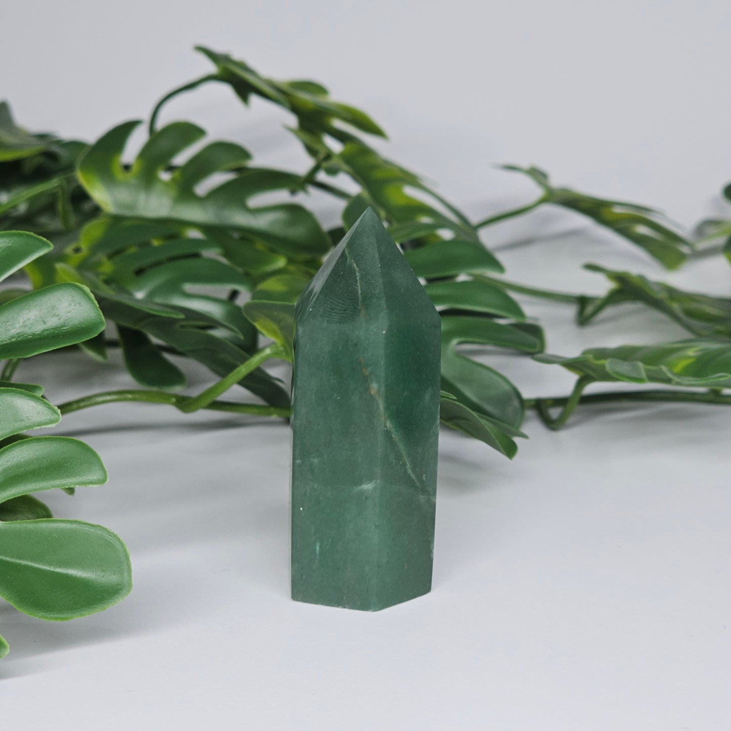 Green aventurine crystal tower for luck and prosperity displayed as home decor