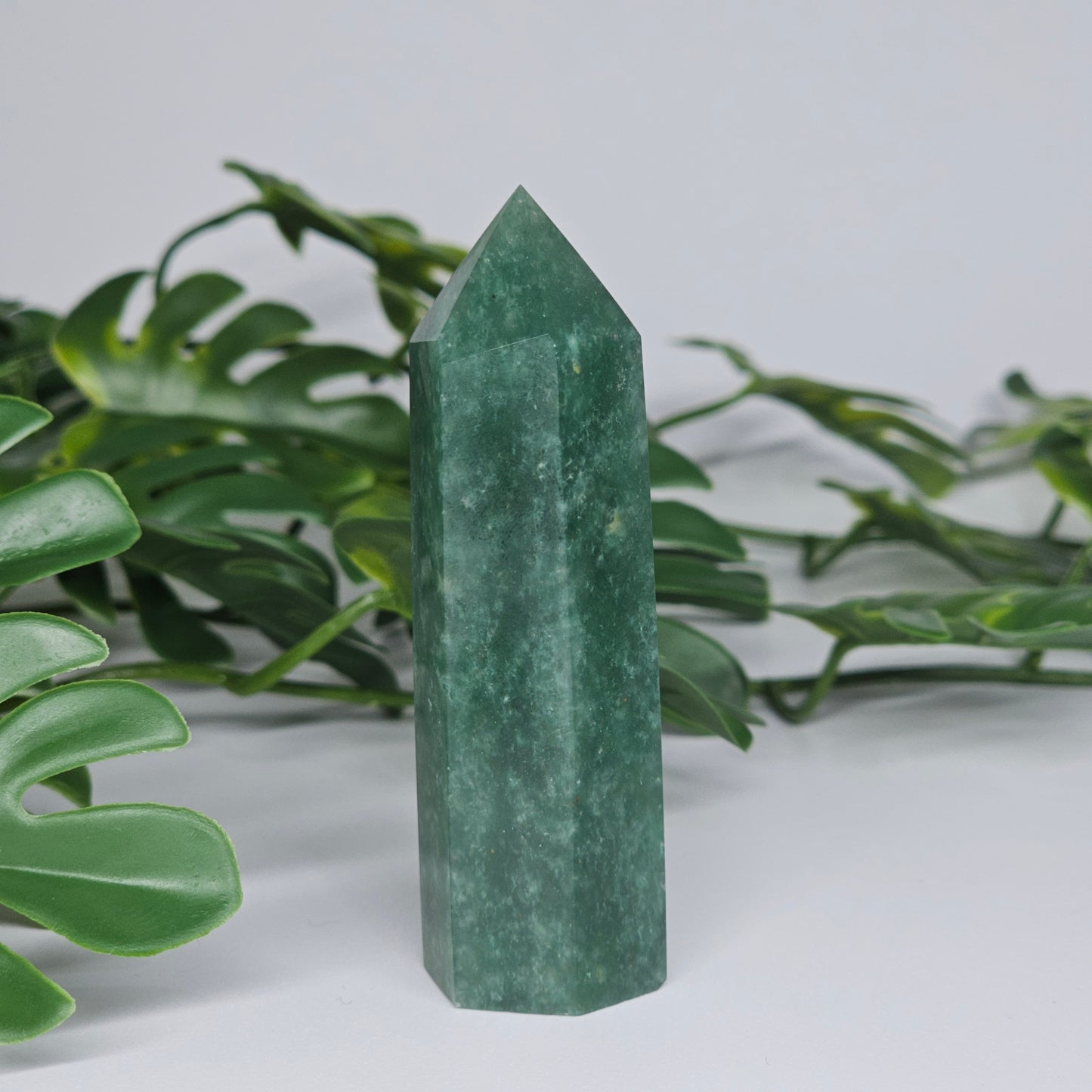 Green aventurine crystal tower for luck and prosperity displayed as home decor