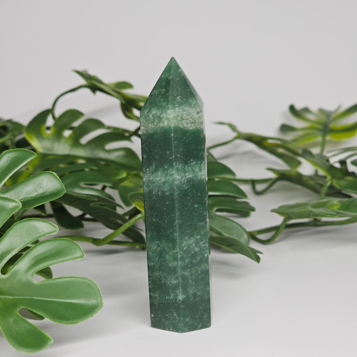 Green aventurine crystal tower for luck and prosperity displayed as home decor