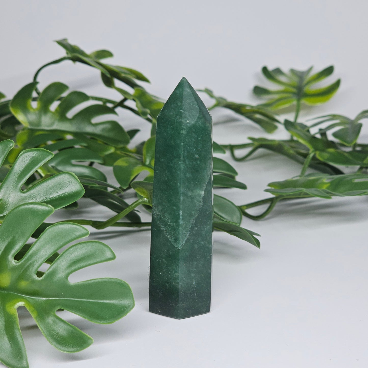 Green aventurine crystal tower for luck and prosperity displayed as home decor