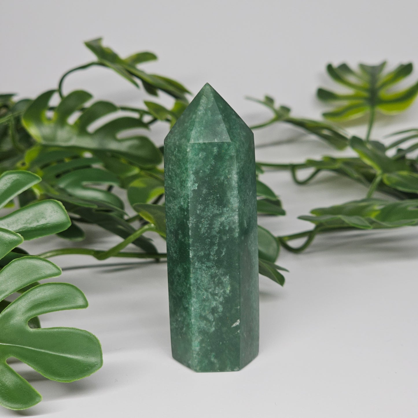Green aventurine crystal tower for luck and prosperity displayed as home decor