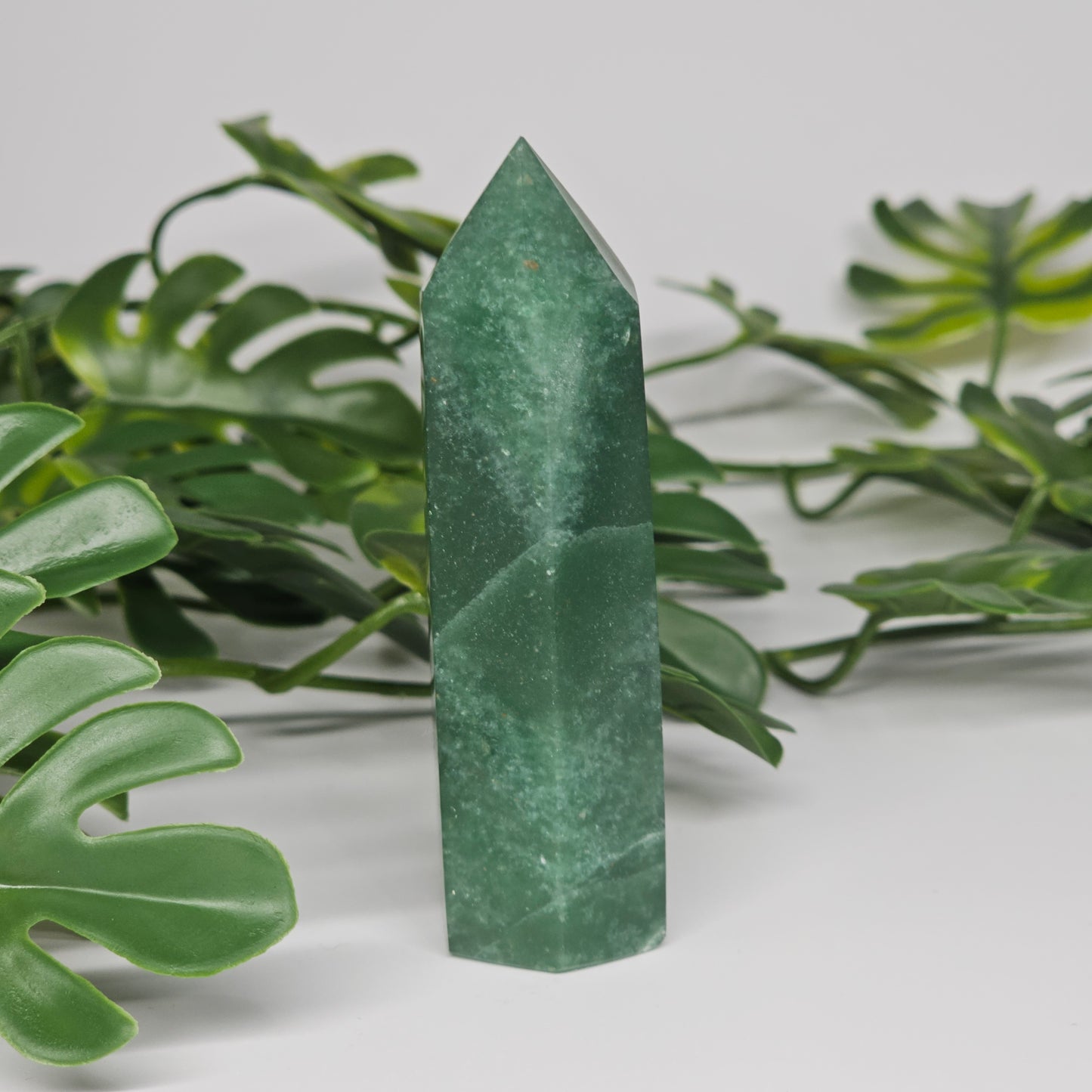 Green aventurine crystal tower for luck and prosperity displayed as home decor