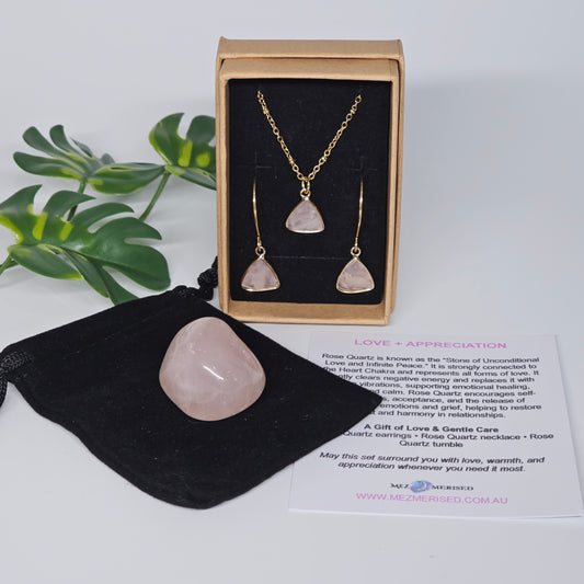Rose Quartz jewellery set with necklace and earrings displayed in gift box, with tumble stone on velvet pouch and information card.