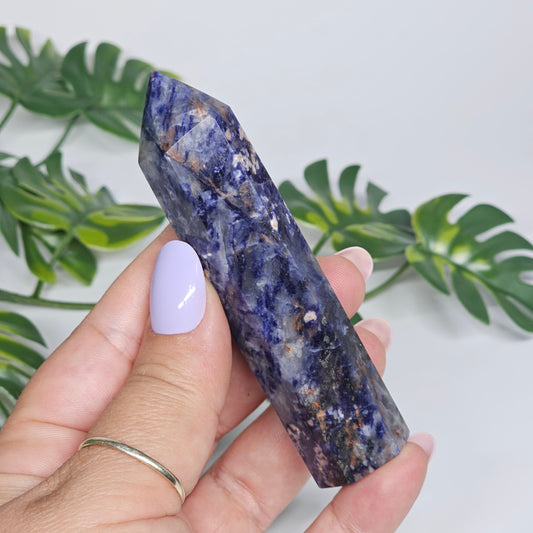 Sodalite tower held in hand showing size and natural pattern.
