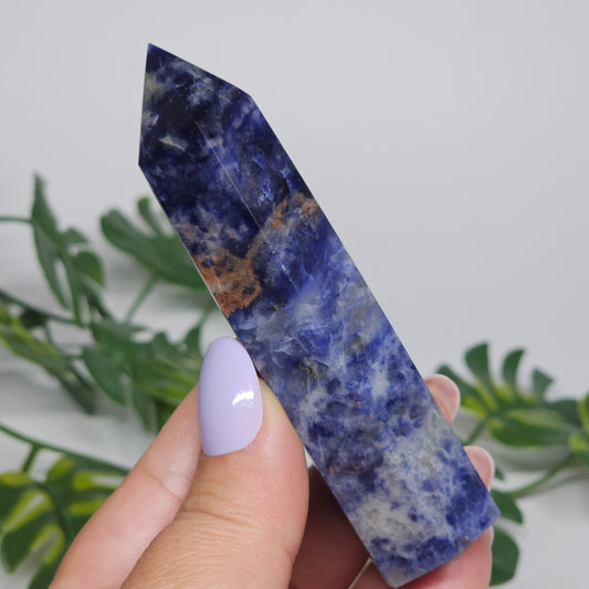 Sodalite tower held in hand showing size and natural pattern.