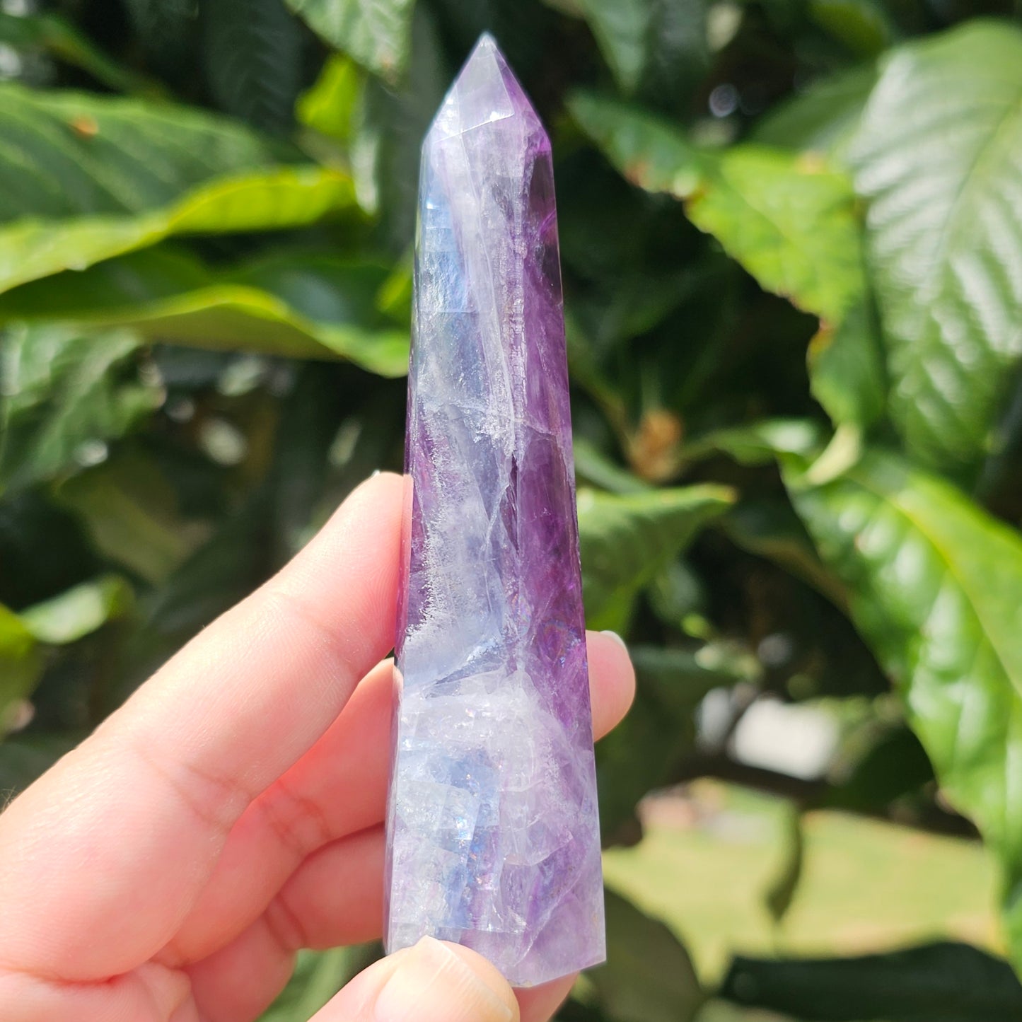 Gorgeous rainbow Fluorite tower with deep purple, blue and green banding. Also has stunning rainbows throughout.