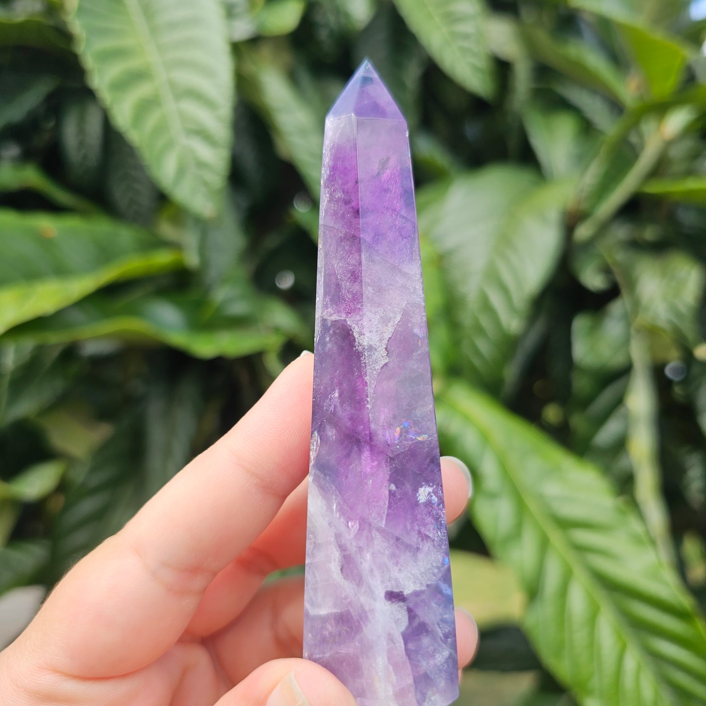 Gorgeous rainbow Fluorite tower with deep purple, blue and green banding. Also has stunning rainbows throughout.
