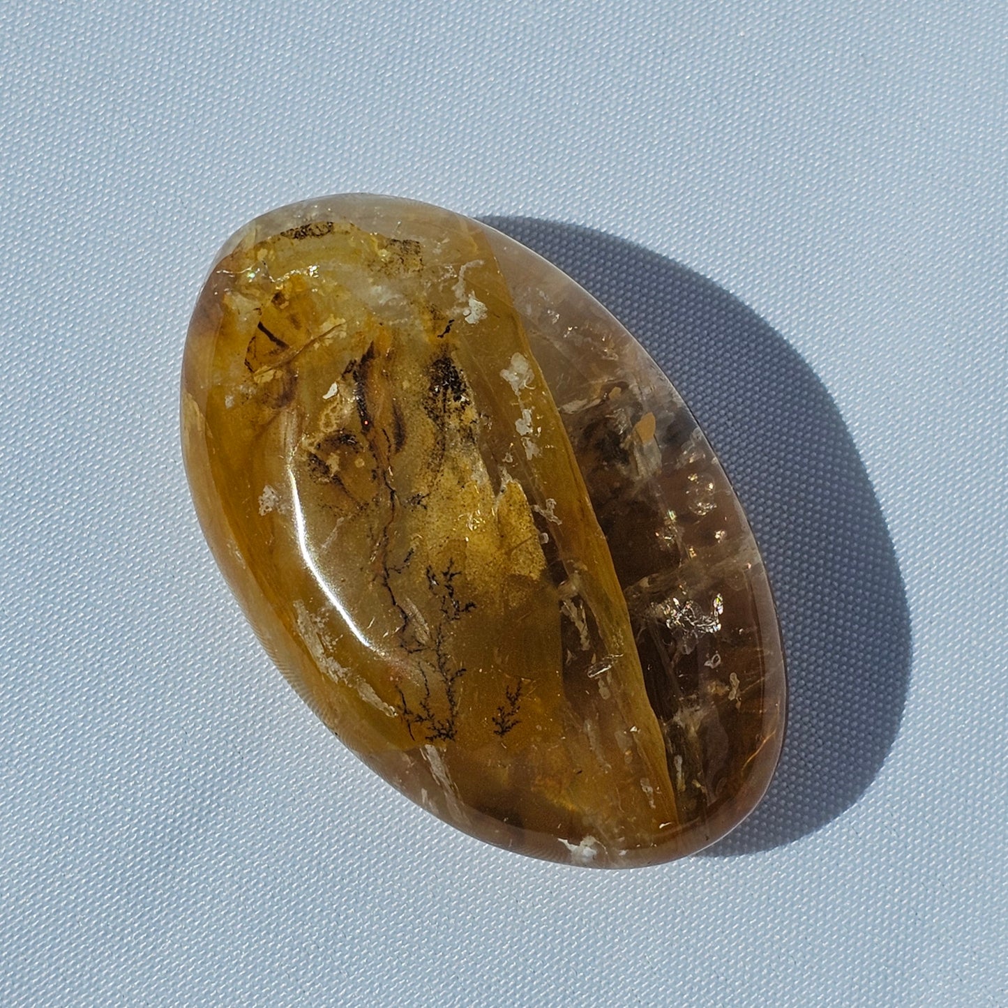 Stunning translucent Golden Healer palm stone with beautiful Dendritic inclusions.