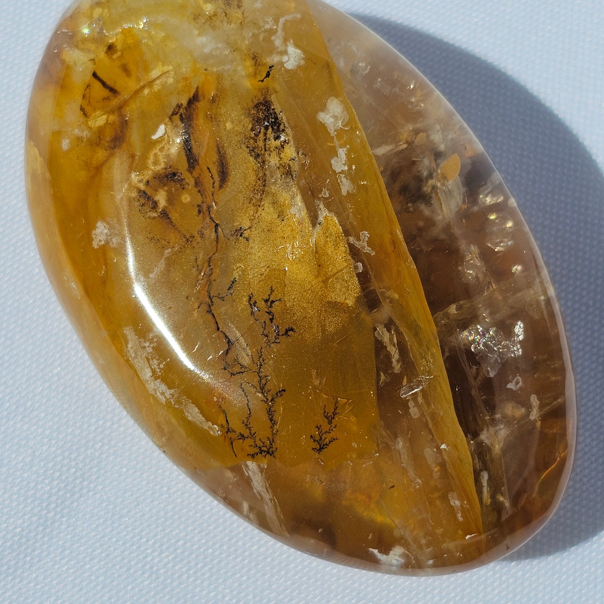 Stunning translucent Golden Healer palm stone with beautiful Dendritic inclusions.