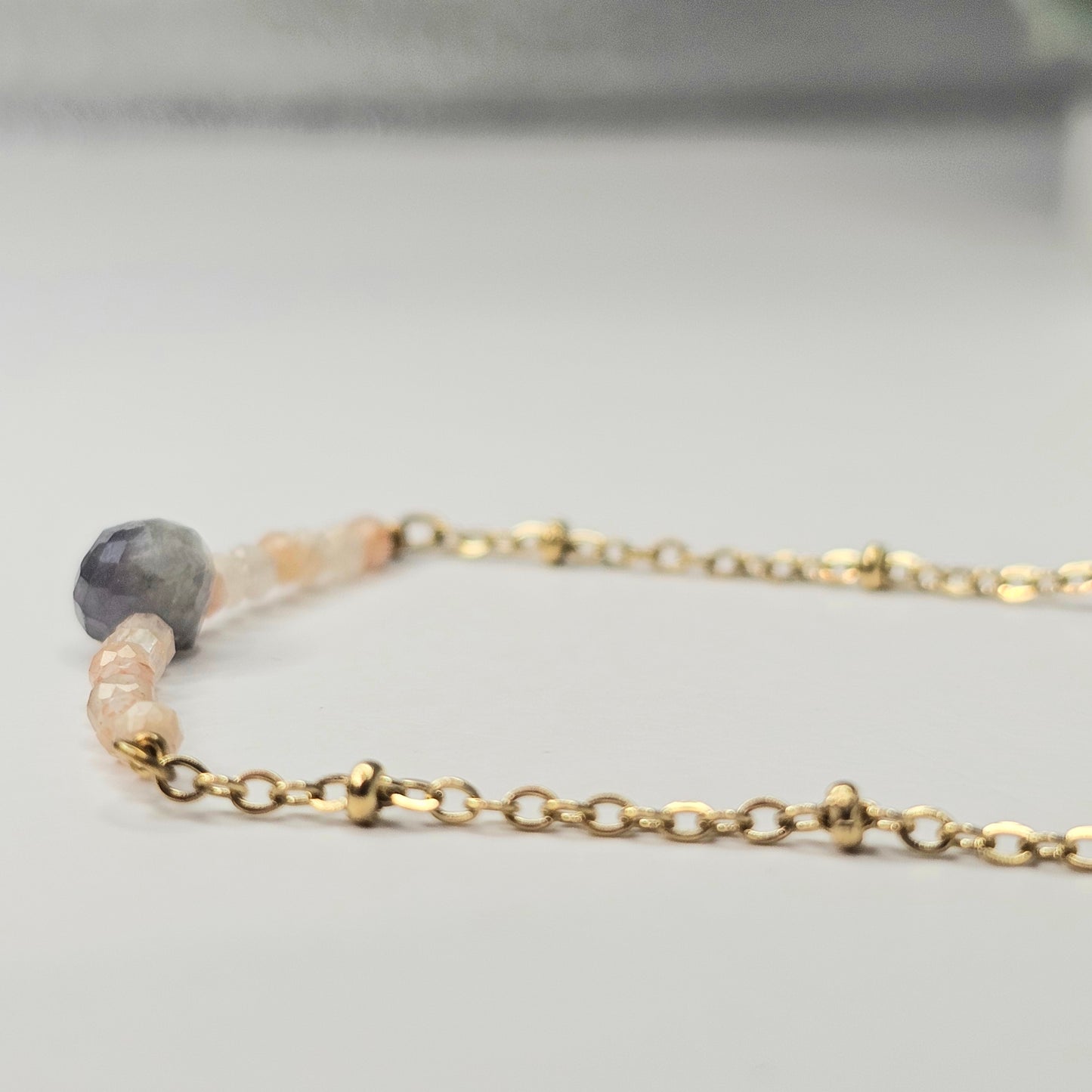 Gold toned stainless steel chain adorned with dainty Lapis Lazuli and Sunstone beads.