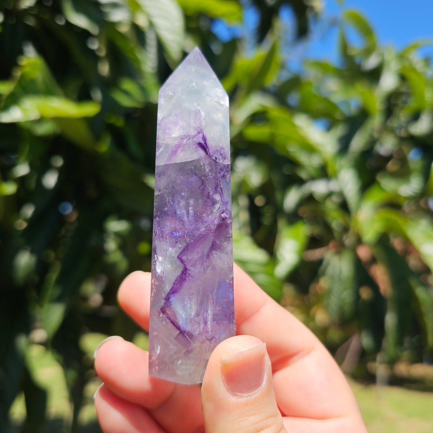 Spectacular clear Fluorite tower with vibrant purple, pastel blue &amp; pastel green banding. Also has beautiful rainbows throughout.