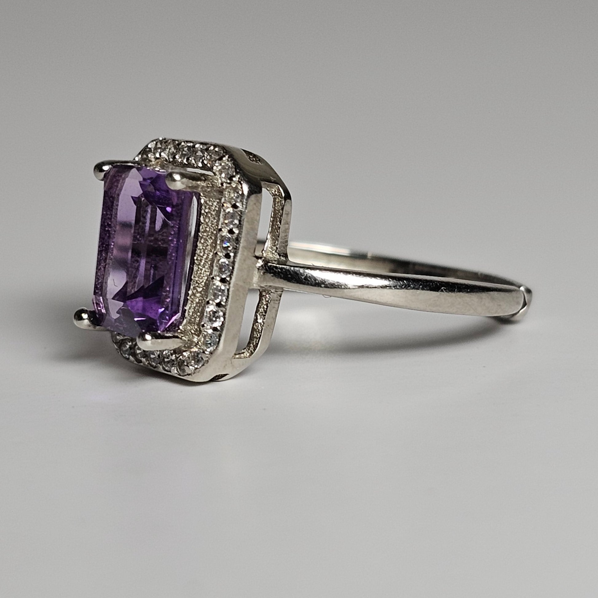 This ring is crafted from sterling silver and features a gorgeous rectangular shaped Amethyst with a Zircon accented crown.