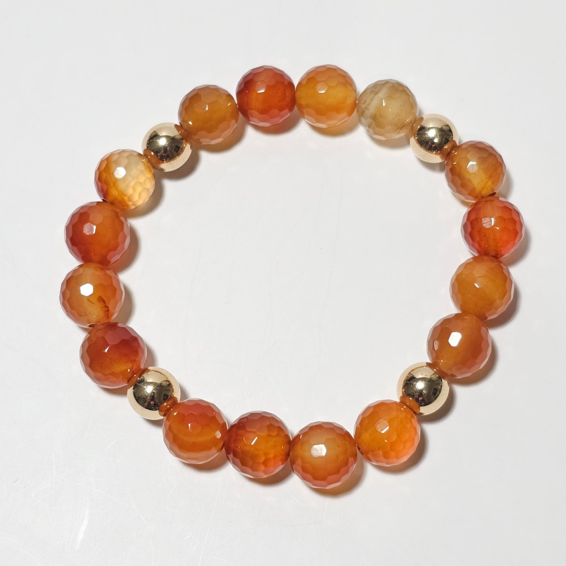 10mm Faceted gorgeous Carnelian and gold plated Hematite bead stretch bracelet.