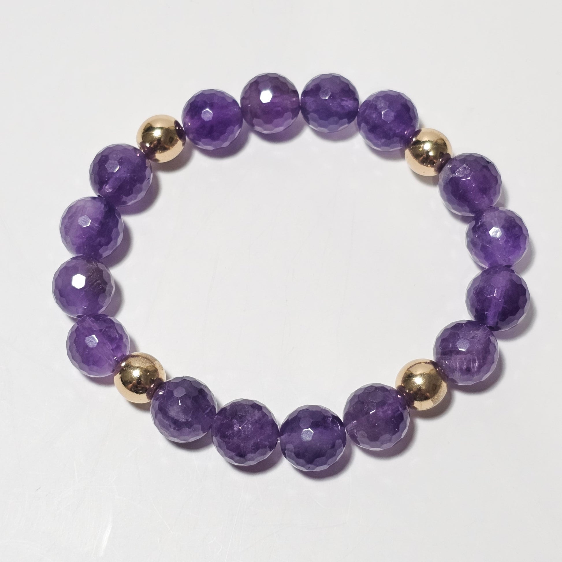 10mm Alluring faceted Amethyst and gold plated Hematite bead stretch bracelet.