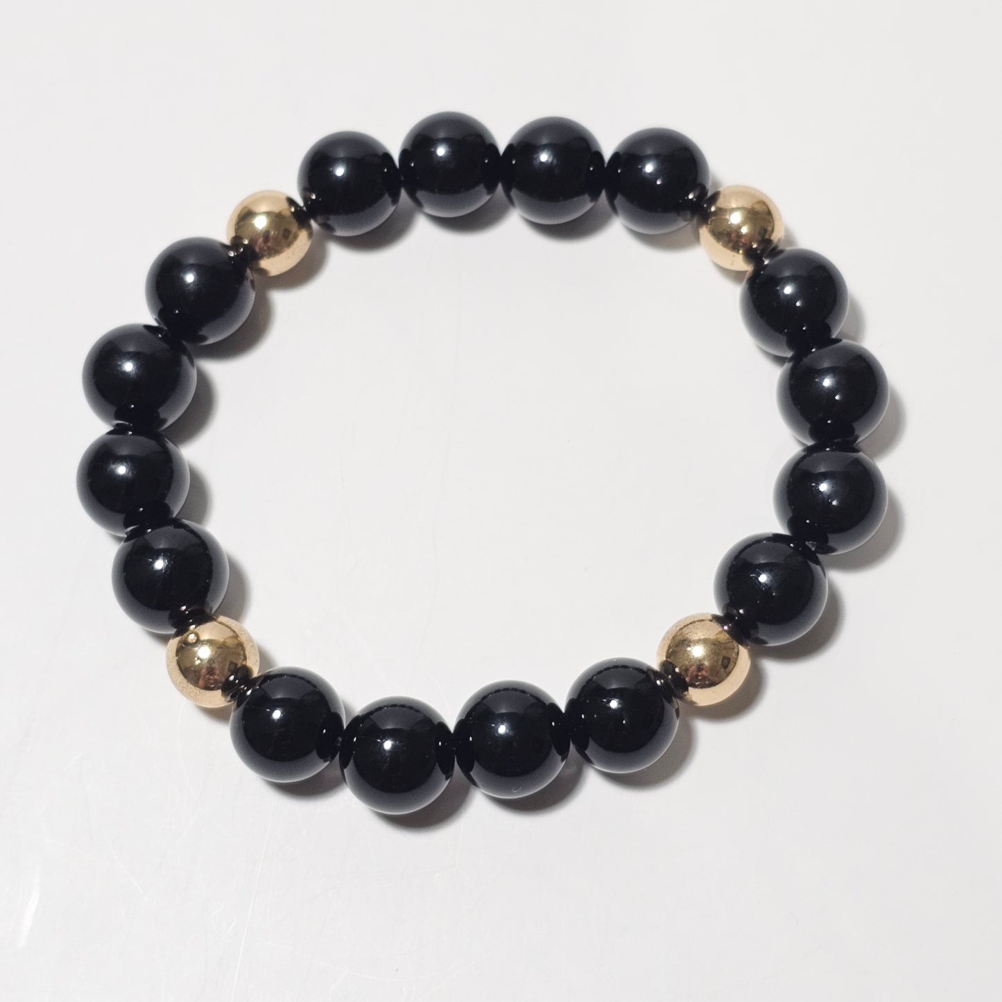 10mm Elegant Onyx and gold plated Hematite bead stretch bracelet.