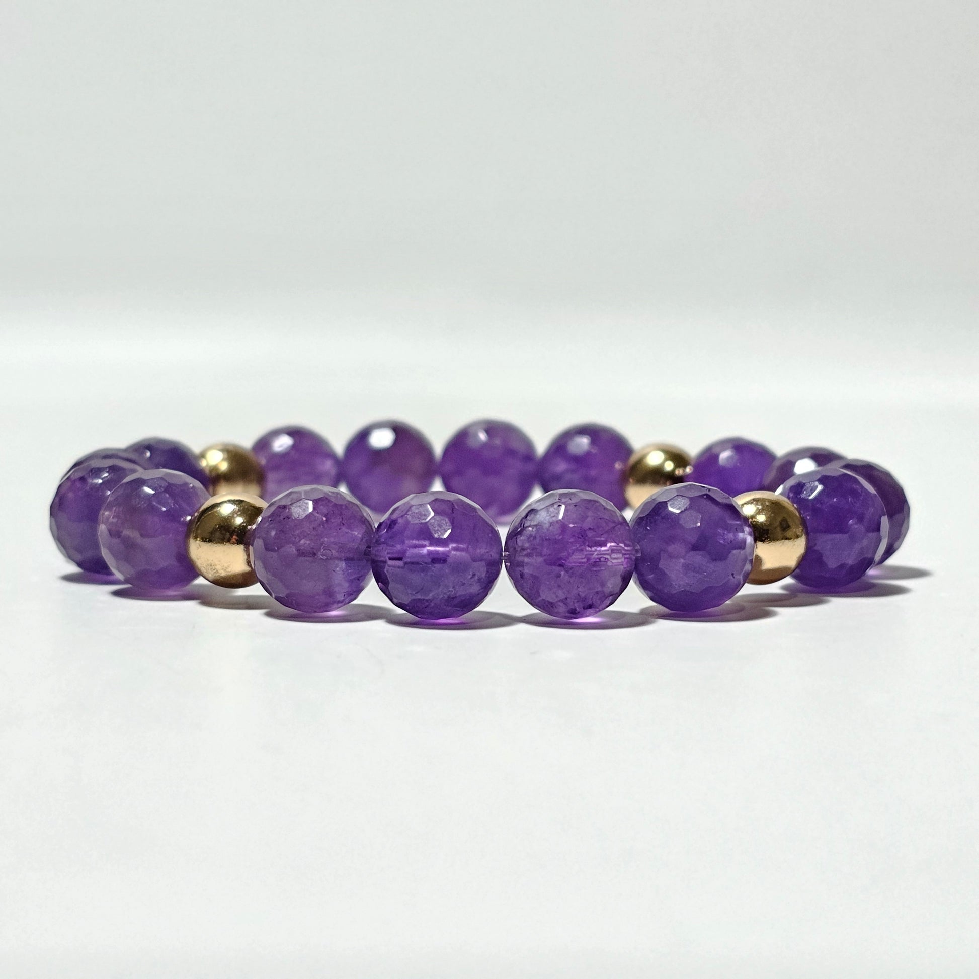 10mm Alluring faceted Amethyst and gold plated Hematite bead stretch bracelet.