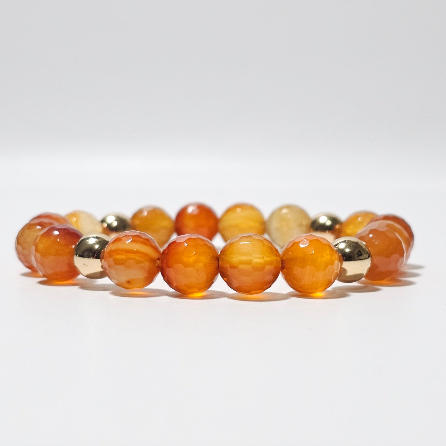 10mm Faceted gorgeous Carnelian and gold plated Hematite bead stretch bracelet.