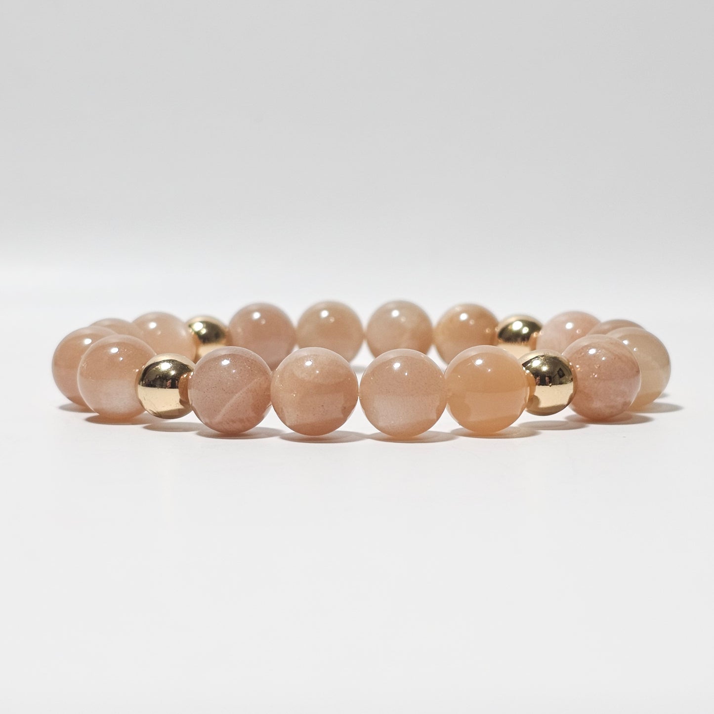 10mm Shimmering A+ grade Sunstone and gold plated Hematite bead stretch bracelet.