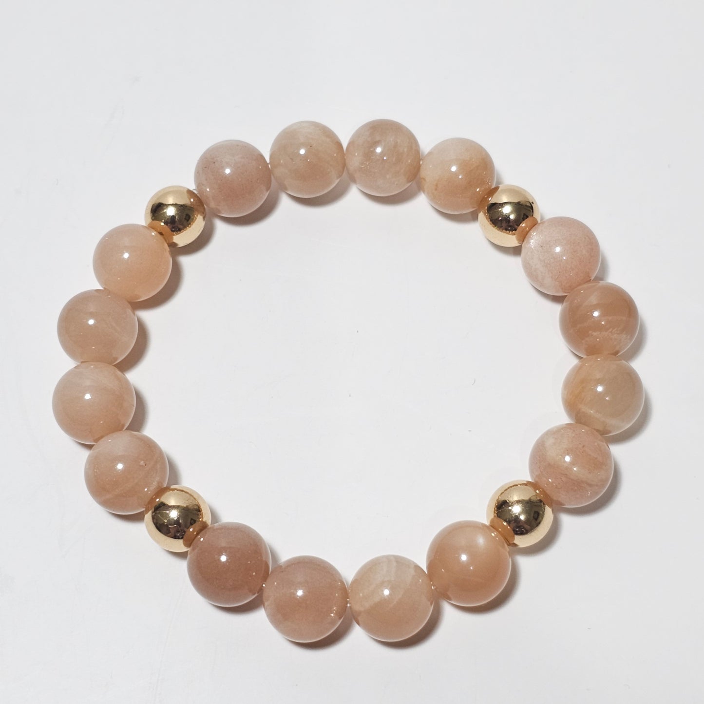 10mm Shimmering A+ grade Sunstone and gold plated Hematite bead stretch bracelet.