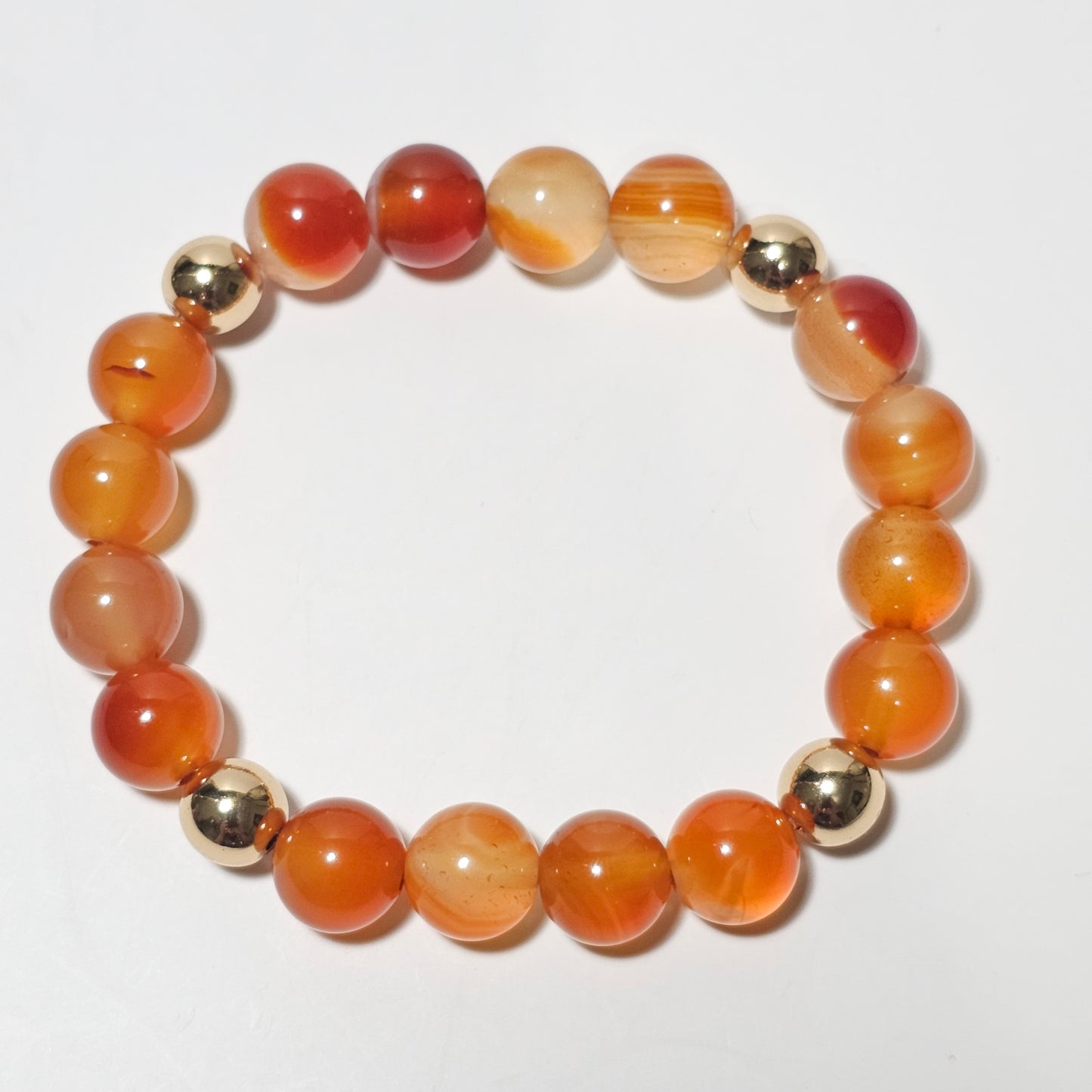 10mm Gorgeous A grade Carnelian and gold plated Hematite bead stretch bracelet.