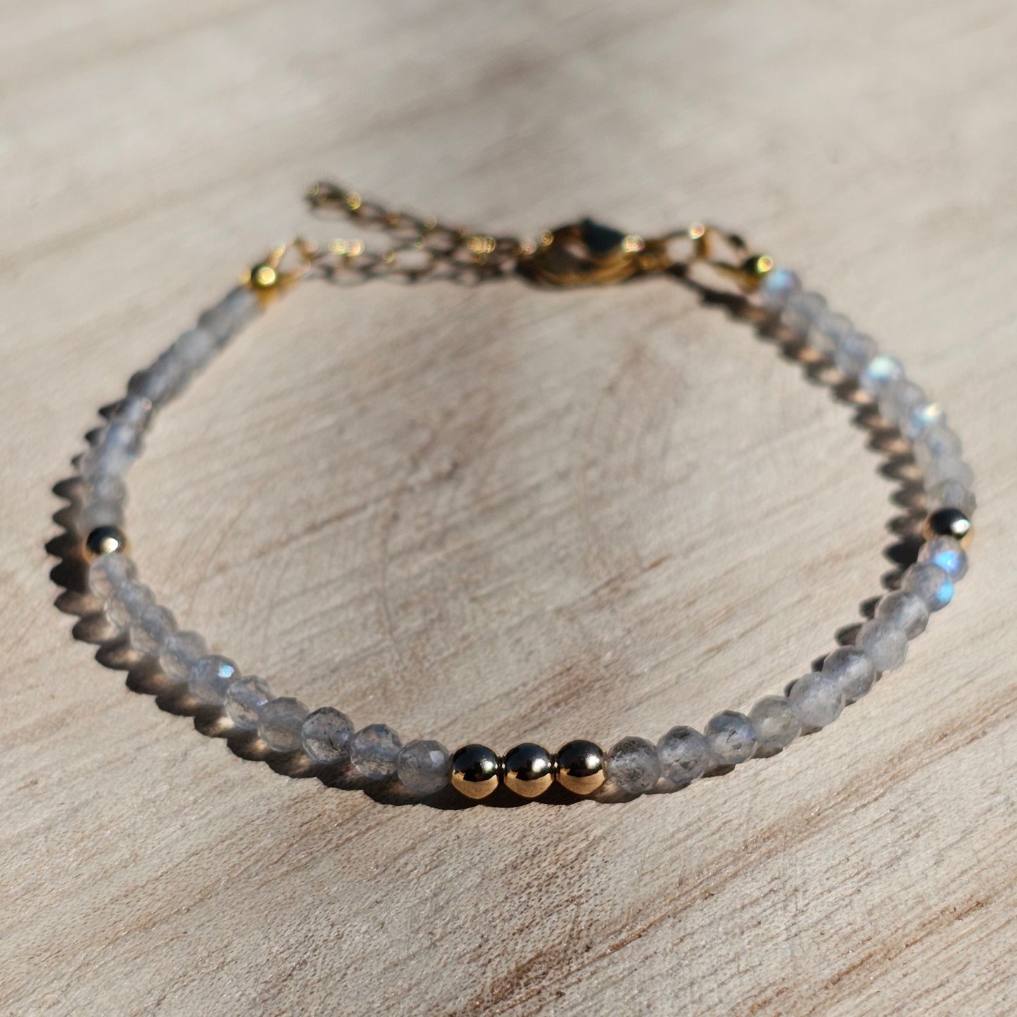 Delicate, faceted dainty Labradorite and AAA grade gold plated Hematite bead bracelet with a gold stainless steel clasp and extender chain.