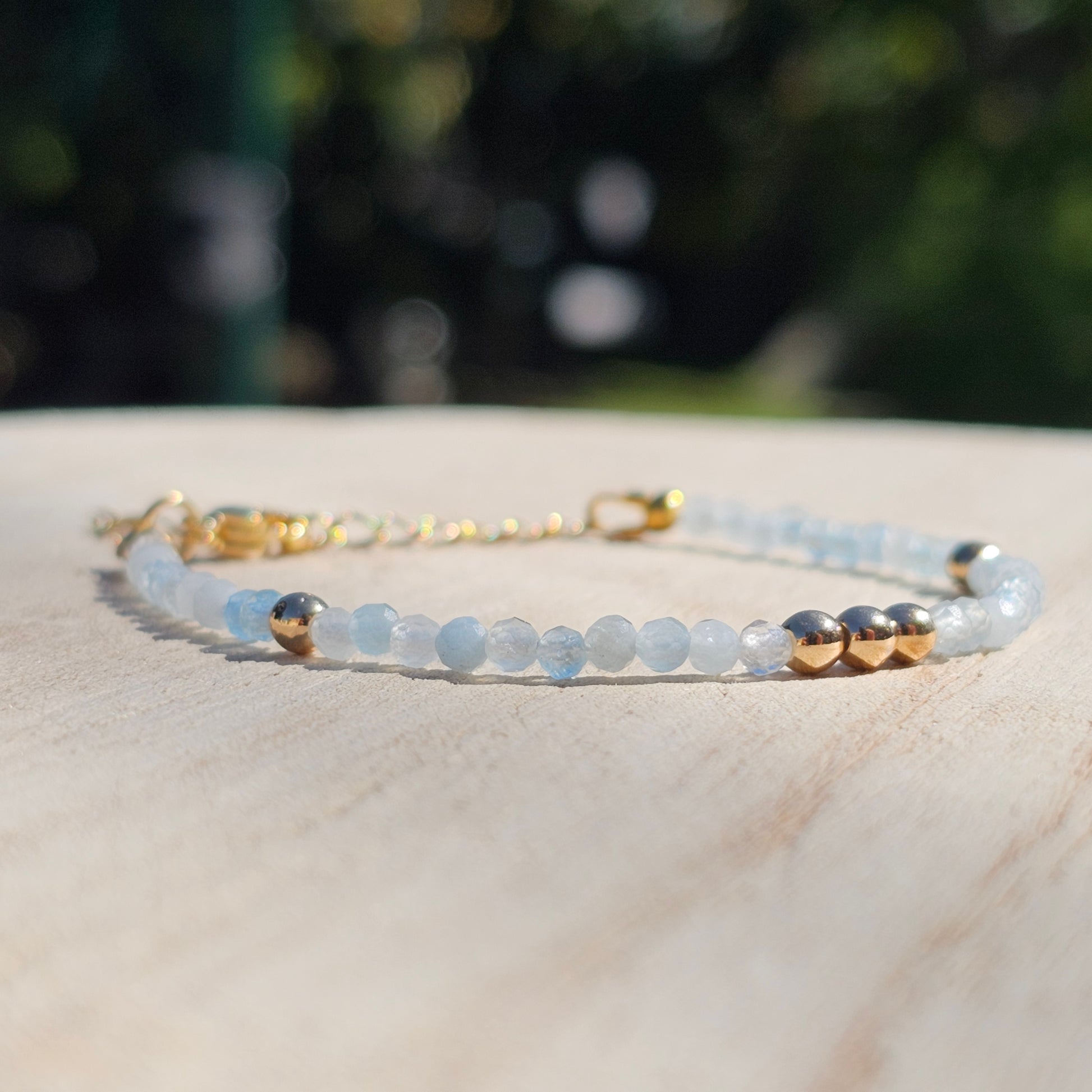 Delicate, faceted dainty Aquamarine and AAA grade gold plated Hematite bead bracelet with a gold stainless steel clasp and extender chain.