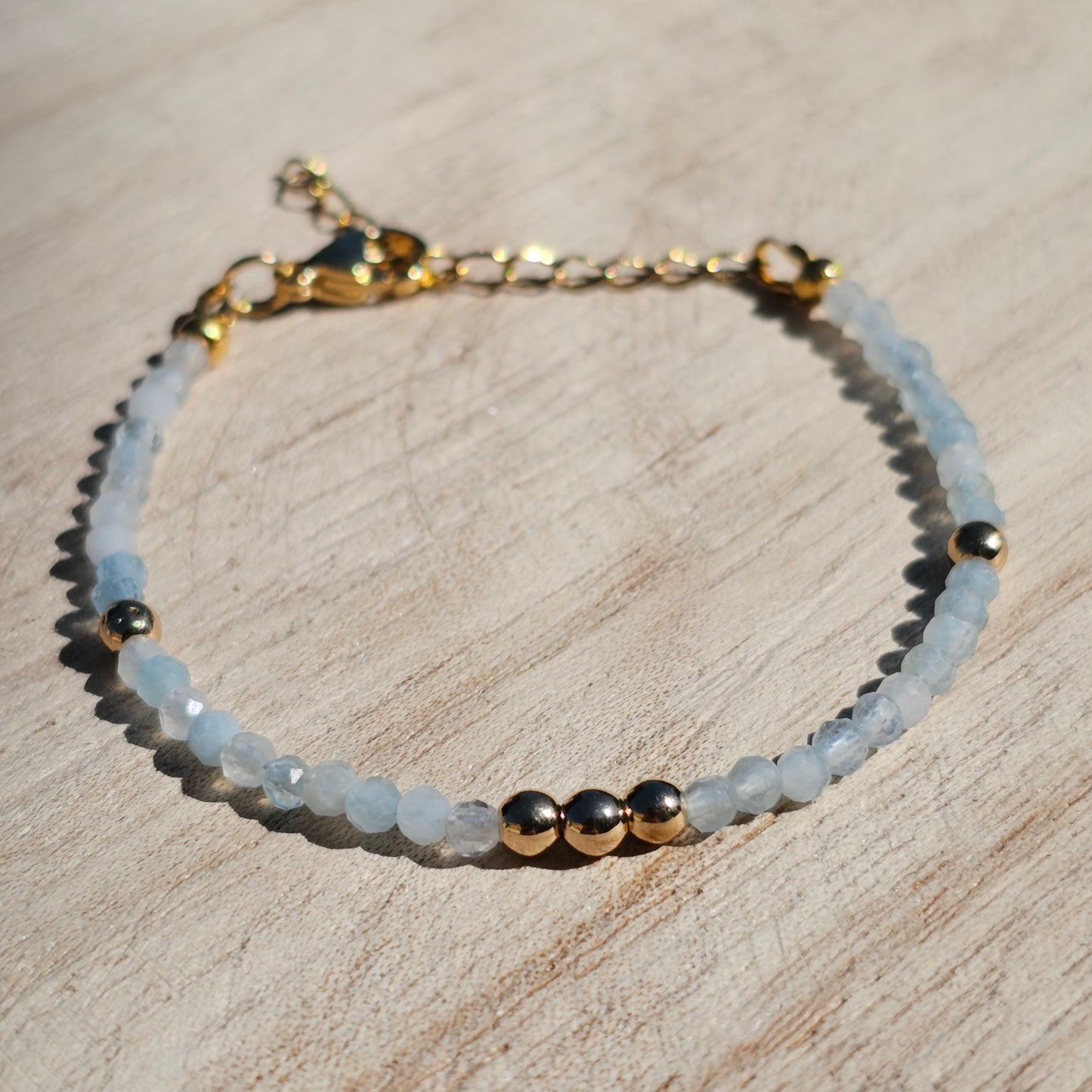 Delicate, faceted dainty Aquamarine and AAA grade gold plated Hematite bead bracelet with a gold stainless steel clasp and extender chain.